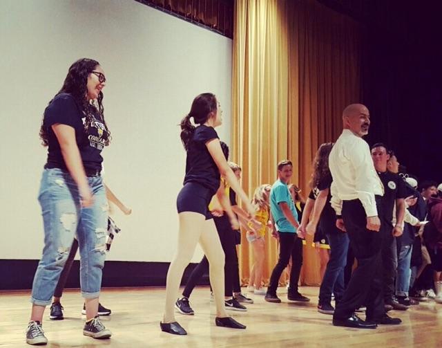 From left to right: Chanelle Irabien, Natali Vazquez, Carlos Cohen performing the Backpack Dance for incoming freshmen