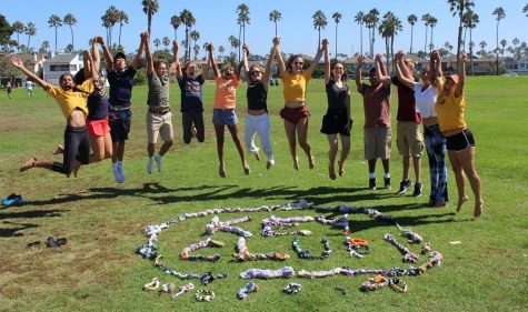Maya Krishnasamy, Rapha Rosalles, Max Cohen, Kate Marsden, Neela Krishnasamy, Peyton Reynolds, Sarah Florez, Sarah Clench, and Valentina Pfeifer at a Key Club beach cleanup spelling out Key Club with the dog toys they had just made for the Humane Society. 
Photo by: Helen Scovell