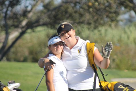 Freshman Carlee Stevenson (El Camino athlete) (left) and Block (right) smile after they tee off the fifth hole.
