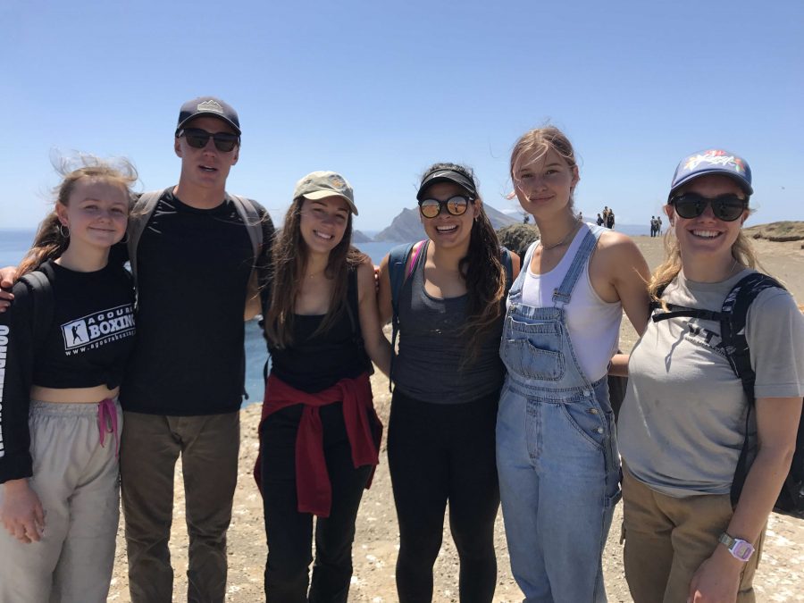 (From left to right) Junior Tanya Turchin, seniors Andy McCombs, Amanda Malotte, Rafaela Rosales, sophomore Olivia Jacobson, and senior Peyton Reynolds posing for a picture during their trip to the island. Photo by: Lily Lara