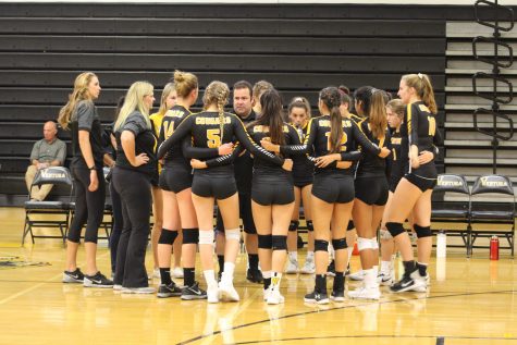 Cougars huddle and listen to their coach, Bryan Ornelas, during a timeout. Photo by: Summer Yovanno