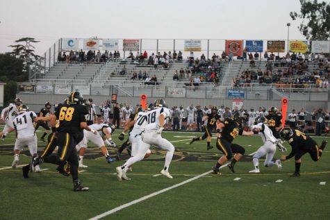 The Cougars offense running a screen play in the second quarter. Photo by: Miles Bennett