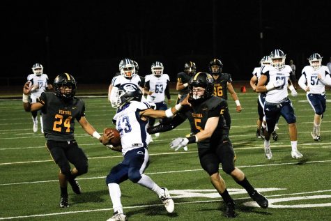 Linebackers Aiden Garza(number 24) and TJ Barlow(number five) attempting to complete a tackle. Photo by: Ryan King