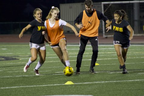 (From left to right) Seniors Elieah Boyd and Alyssa Moore, coach Nick Frannick and junior Tiffany Hernandez scrimmaging on the first tryout night. Photo By: Summer Yovanno