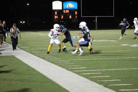 Junior Jadon Cline (number 17) breaking a tackle before being pushed out of bounds. Photo By: Gavin Cross