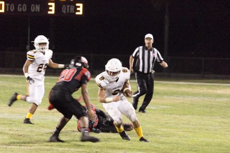 Senior Noah Conboy (number eight) ready to lower his shoulder for the hit. Photo by: Gavin Cross
