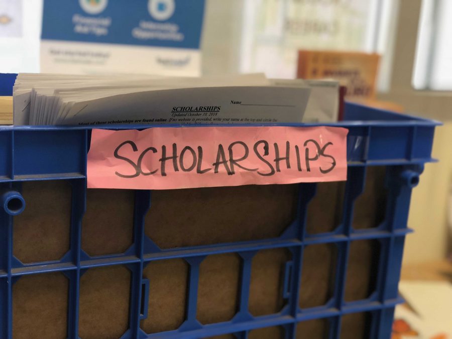 There is a box full of papers on scholarship opportunities in the career center. Photo by: Sarah Clench