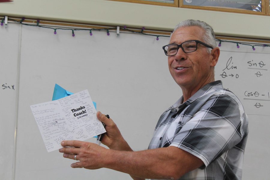 Steward shows off a card signed by his football players to his 4th period Calculus class the day after freshman footballs end of season banquet. Photo by: Lola Bobrow