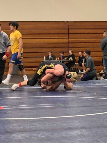 Junior Riley Beeson, keeping his opponent down on the mat in a hold, securing a win for this match. Photo by: Essex Gilbertson