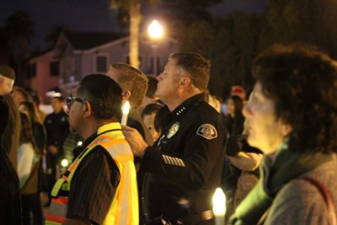 Community members stand with their electric candles. “We lost more than property,” said Endaya. “We lost a couple of lives, that are too, too many.” Photo by: Micah Wilcox