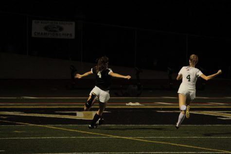 As Senior Cassidy Hubert (number four) sprints down field, she attempts a mid range shot hoping to score the Cougars first goal. Photo By: Gavin Cross