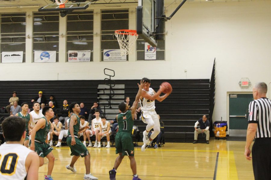 Junior Andrew Ramirez (number 20) with an impressive save pass to Senior Mateo Fuentes who went on to shoot a buzzer beater at the end of the third. Photo By: Malik Hibbler