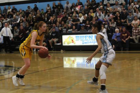 Junior guard Sammie Henley (number 25) dribbles forward as a Buena player moves to intercept her. Photo by: Dylan Gildea