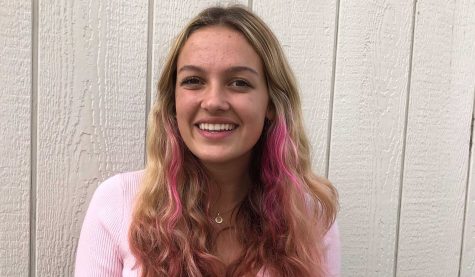 Junior Emma Lisle rocks her half-pink cotton candy hair in the breezy wind. Photo by: Jocelyn Lee