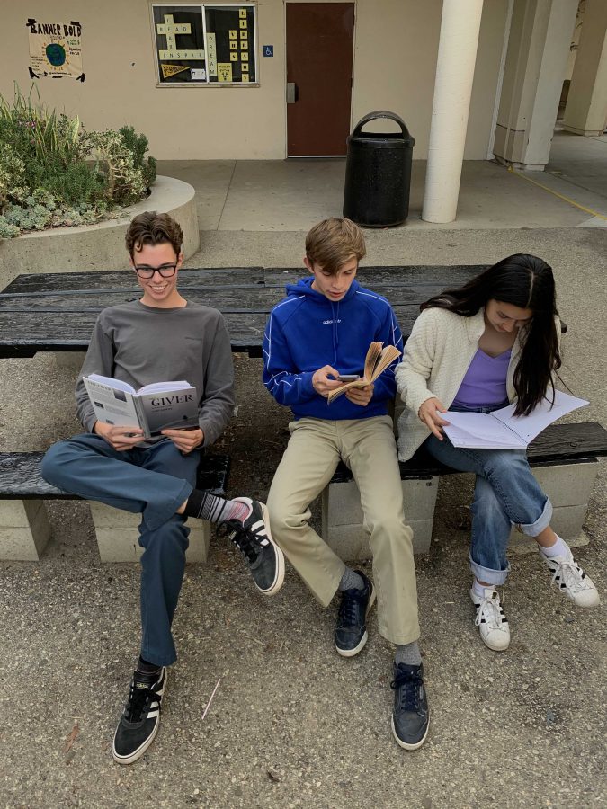 (From left to right) Sophomores Iman Costa, Yves Declerck, and Chiali Lavalle going over school work. Photo by: Jack Schatzman