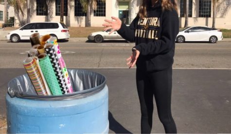 Sophomore Izzy Eulenhoefer says she is so surprised that there is so much waste during the holidays as she gestures to a trash can with photoshopped wrapping paper. - photo by Audrey Flynn