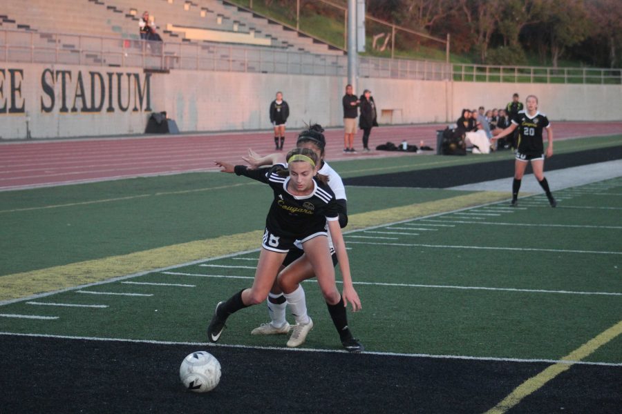 Freshman Maddy Dannenberg (number 8) fights for the ball against Rio Mesa. Photo by: Jocelyn Lee