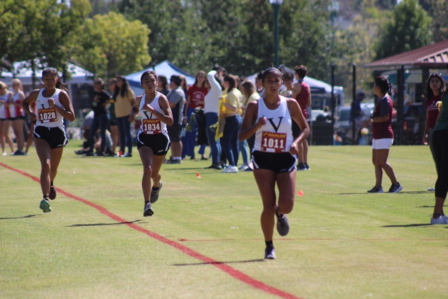 (Pictured left to right) Seniors Sammie Prehn, Rita Soriano-Flores, and Julianna Garcia racing hard in their sport, cross country. Photo by: Bill Tokar