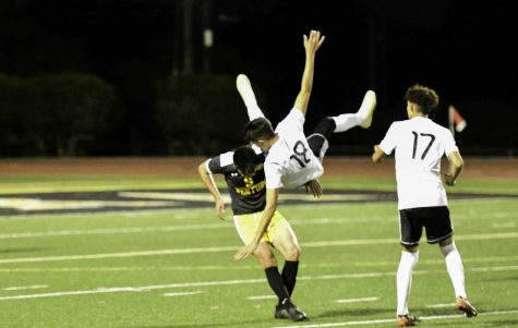 Senior Danny Gutierrez (number 9) sends Pacifica (number 18) flying. Photo by: Gene Dunn