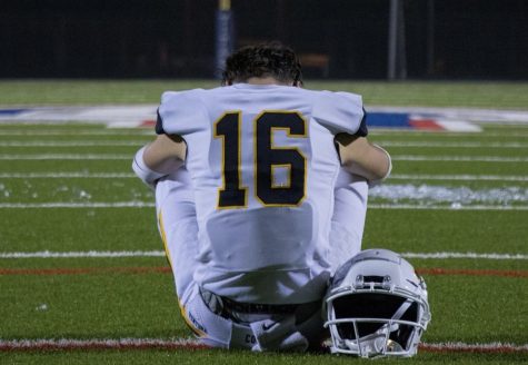 Senior Logan Bobis sat in the middle of the field after his last game, the semifinals against Colony High School. Photo by: James Rail