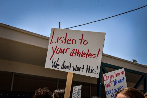 Protestors held signs, like pictured, including sayings such as shame on you, we want our coach back targeted at VHS administration. Photo by: Adi DeClerck
