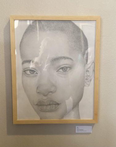 Washington, who is the artist of this work, said, [They figured out their art was being put in the showcase] by Mrs. Minadeo submitting it and then she just told me that it was going to be on the cover of the poster [promoting the exhibit].” Photo by: Avea Baker
