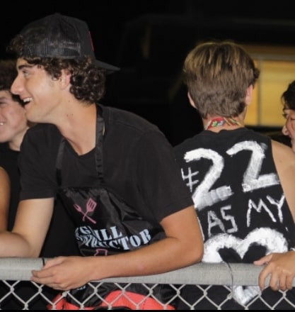 Jack Rose (left) and Jake Auster (right) in the student section at the homecoming game. Photo by: Ella Montano
