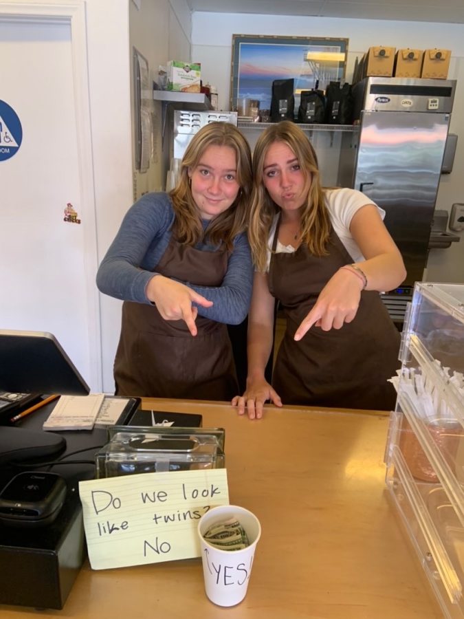 Hannah Stamp 23 (left) and Malana Morton 23 (right) point to the tip jar at The Coffee Copper Pot Cafe. Teens with part-time jobs make money they can use on whatever they prefer. Whether it be their tips or their pay check, they have the freedom to manage their own money. Photo by: Lily Carnaghe
