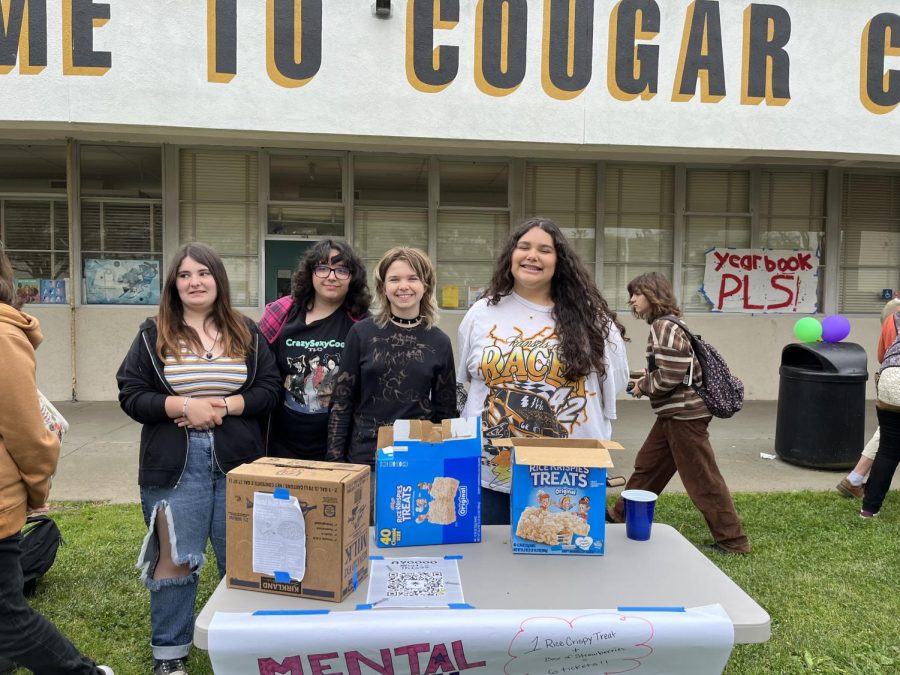 Andrea Sosa ‘25, Natalia Zuniga ‘25, Duncan Kenton ‘24 and Kamilah Montes De Oca ‘25, left to right. Montes De Oca said, “This is the Mental Health Awareness Club and we are selling rice krispies for two tickets and chocolate covered strawberries for five tickets. [We are participating because] mostly to promote our club, to let people know that we’re around and that we want to do some stuff [to] get more members and stuff like that.” Photo by: Kendall Garcia 
