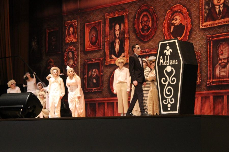 Owen Siegmund 24, center-right, who played Lurch, walks towards the Addams Family coffin. Photo by: Katie Rundle