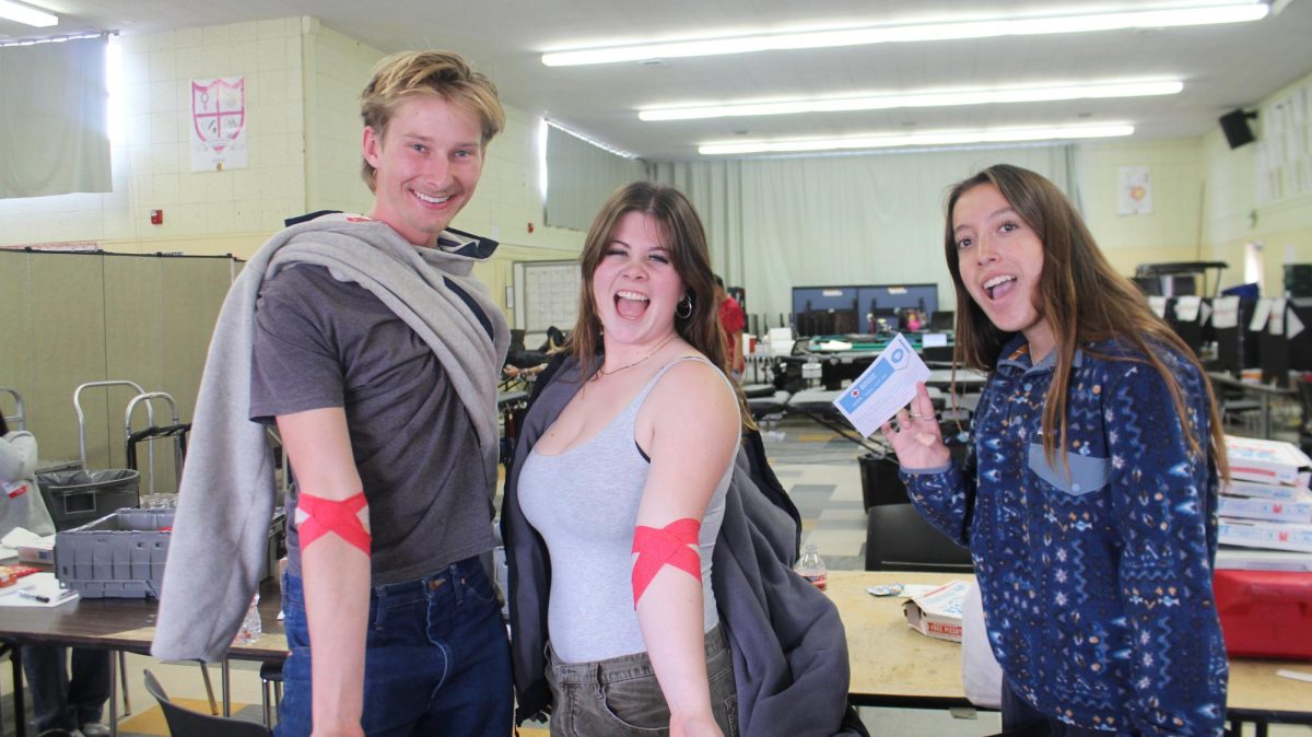Students and other donors waited in the cafeteria to get their blood drawn. (Pictured left to right) Thomas Atkins 25, Ruby Welch 25 and Annabella Lehtonen 25. Photo by: Alexis Segovia
