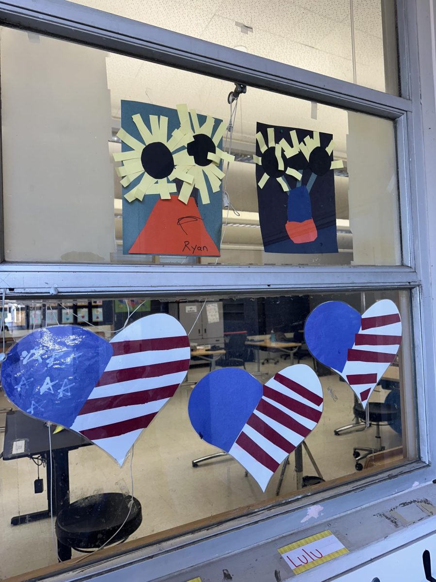 Crafted American-flag hearts made by students can be posted up in the 80s-90s classrooms windows. Photo by: Sophia Denzler
