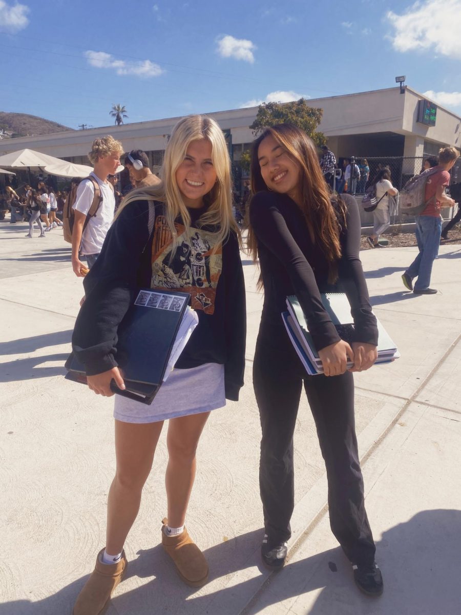 Left to right: Bailey Burman '25 and Jenny Truong '25. Burman said, "Fall is the best season for crewnecks and Uggs." Photo by: Ella Duncan.